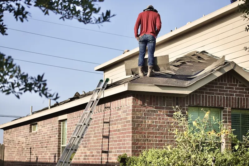 Professional roofer working on a residential roof in Lancaster